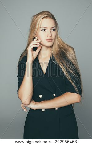 Beauty Woman Face Portrait. Beautiful Model . Blonde Female Looking At Camera And Smiling On Gray Ba