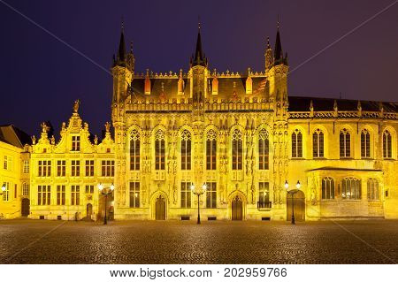 The illuminated town hall of Bruges with dark night sky.