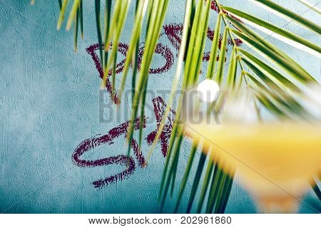 Summer  Cocktail -  Pornstar Martini. Drink with Passion fruit, Vodka, Liquor, Vanilla Syrup, Champagne and Lime Juice. Tropical Leaf on Background
