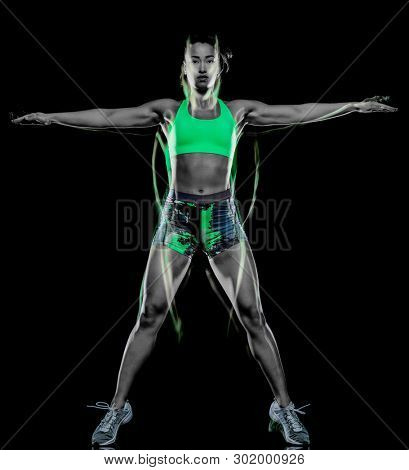 one mixed race woman exercising fitness exercises isolated on black background with lightpainting effect