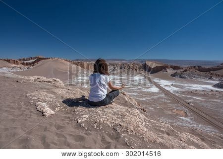 Rear View Of Woman Practicing Yoga In Moon Valley, Atacama