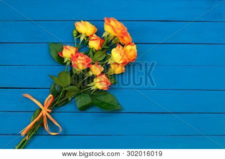 Background Of A Bouquet Of Beautiful Fresh Vivid Orange Roses Tinged With Red For Celebrating An Ann