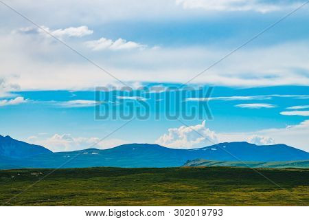 Spectacular View Of Giant Mountains With Snow. Huge Cloud Above Mountain. Big Rocky Cliff Above Abys