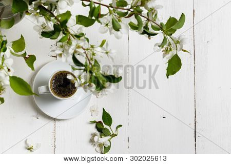 Little Delicate Elegant Bouquet Of Spring Flowers And A Teacup On White Wooden Table, Morning Breakf