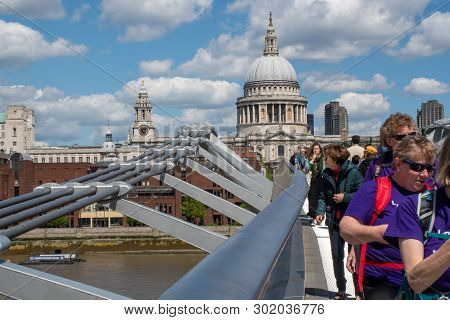 St Pauls  London  United Kingdom  -12 May 2019: Tourists Crossing Millenium Bridge With St Pauls Cat