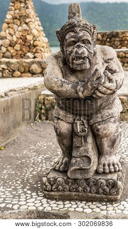 Bali, Indonesia - February 25, 2019: Ulun Danu Beratan Temple Complex In Bedoegoel. Gray Stone Statu