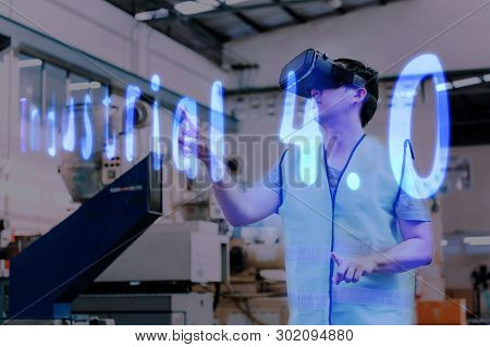 Factory And Manfacturing Engieering Worker Wearing Vr Goggle Headset Touching Industrial 4.0 Text On