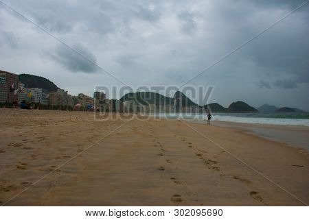 Rio De Janeiro: The Most Famous Beach, Copacabana Beach In Cloudy Weather. Brazil