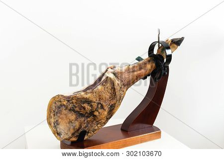 Spanish Delicatessen Dry Cured Meat Ham, Whole Leg, Jamon Iberico Bellota On Jamonero Stand Selectiv