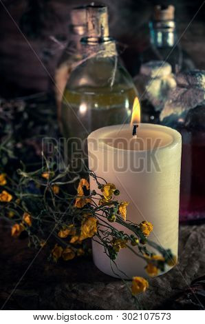A Witchery Stuff: Multiple Tincture Bottles, Bunches Of Dry Healthy Herbs, Stack Of Ancient Ritual T