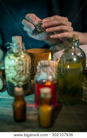 Dark Witch At Work: Black Magic Woman Makes The Witchery By Mixing Herbs, Casting The Spells, Runnin
