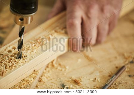 Extreme Closeup Of Unrecognizable Carpenter Drilling Wood While Working In Joinery, Copy Space