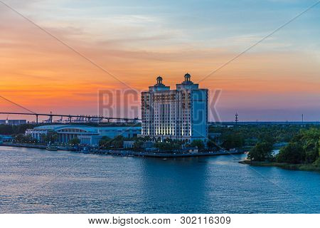 A Massive Savannah Hotel At Dusk On The River