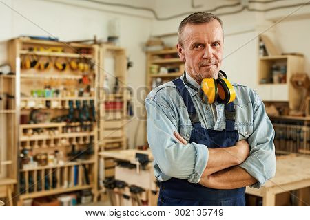 Waist Up Portrait Of Confident Senior Carpenter Looking At Camera While Posing In Joinery, Copy Spac