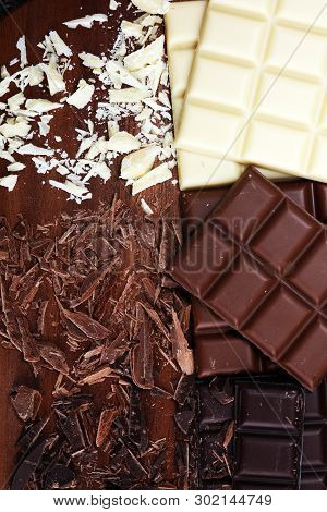 Chocolate In Diffrent Color. Milk, Dark And White Chocolate Bars On Table