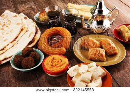Middle Eastern Or Arabic Dishes And Assorted Meze, Concrete Rustic Background. Turkish Bread Or Turk