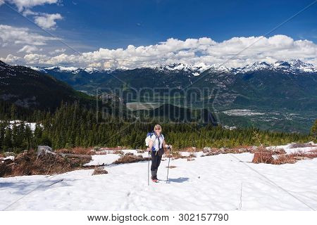 Active Vacation Near Whistler, British Columbia. Smiling Middle Age Woman Hiking On Mountain Top Wit