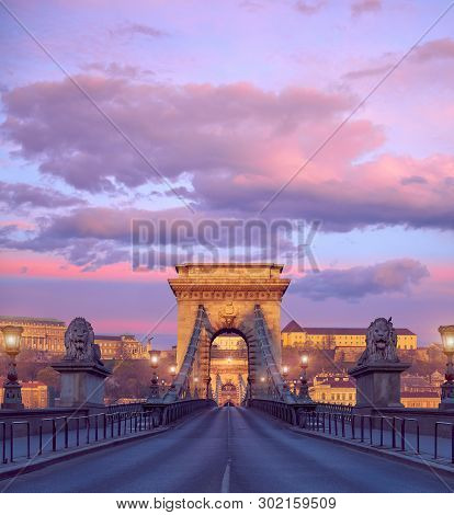 Budapest Castle And Famous Chain Bridge In Budapest On A Sunrise. Focus On The Bridge.