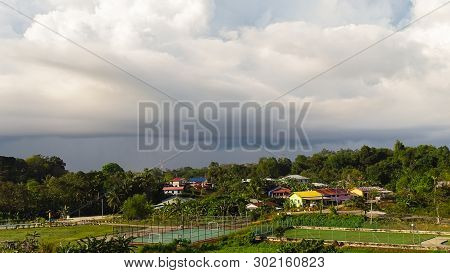 Rain Clouds Over The Village Rural Landscape In Bukit Kalam,labuan Island,malaysia.