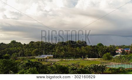 Rain Clouds Over The Village Rural Landscape In Bukit Kalam,labuan Island,malaysia.