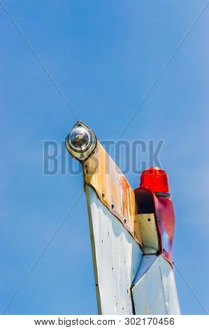 Tail Fin, Rudder And Beacon Lights, Small Single Engine Airplane With Old Paint And Bright Blue Sky.