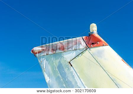 Tail Fin, Rudder And Beacon Lights, Small Single Engine Airplane With Old Paint And Bright Blue Sky.