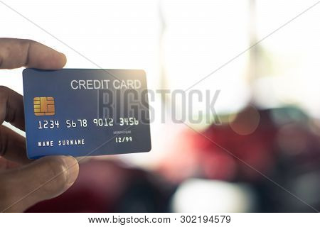 Man Holding Credit Card For Car Blurred Bokeh Background E-shopping