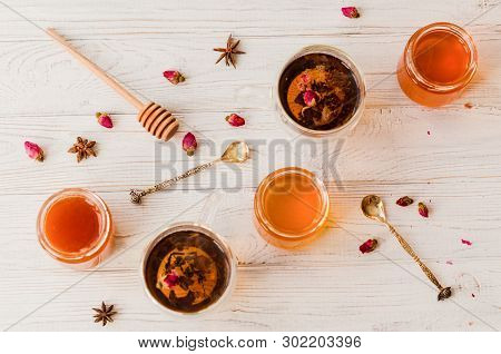 Composition With Honey, Tea And Tea Accessories On A White Wooden Background.