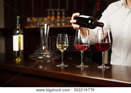 Sommelier Pouring Different Types Of Fine Wine