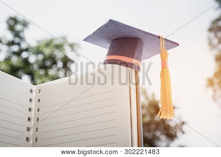 Graduation Cap On White Notebook With Champion Show Success In Education Learning Study Internationa