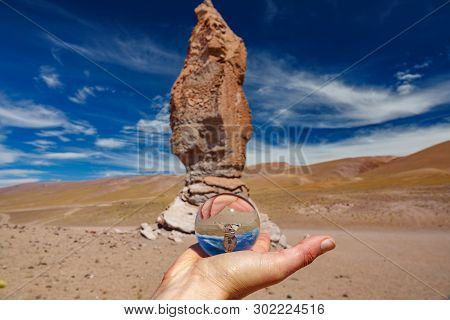 Right Hand Holding Crystal Ball Near Pacana Monks