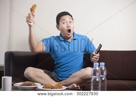 Asian Man Watching Soccer On Tv