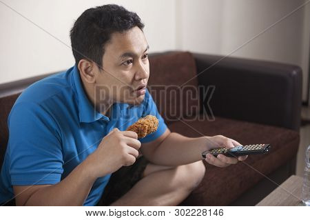 Asian Man Watching Soccer On Tv
