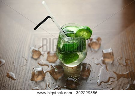 Cucumber Cocktail With Ice Cobe On Wood Background