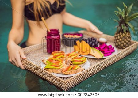 Breakfast Tray In Swimming Pool, Floating Breakfast In Luxury Hotel. Girl Relaxing In The Pool Drink