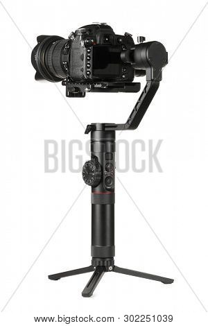 Gimbal three-axis motorized stabilizer with mounted DSLR camera isolated on white background