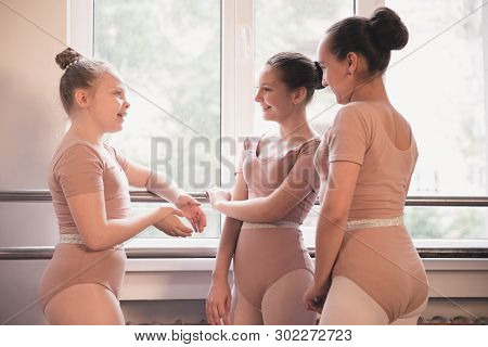 Young Graceful Female Ballet Dancers Dancing At Training Studio. Beauty Of Classic Ballet. Girls Res