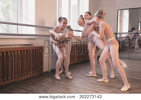 Young Graceful Female Ballet Dancers Dancing At Training Studio. Beauty Of Classic Ballet. Girls Res