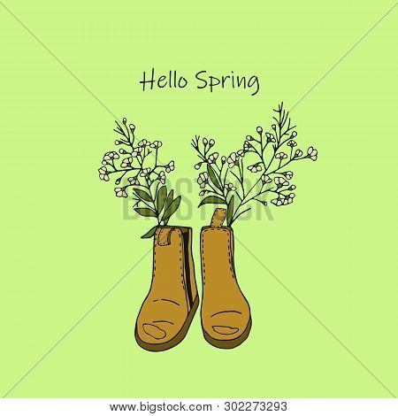 Pair Of Yellow Boots With Flowers Isolated On Green Background