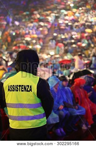 Many People During A Live Concert And A Boy With Jacket With Text Assistenza That Means Assistance I
