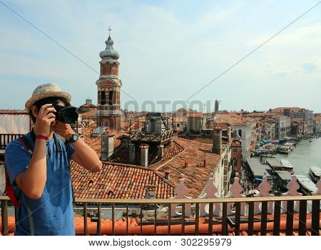 Boy With A Straw Hat Photographs The Panorama Of Venice From Above