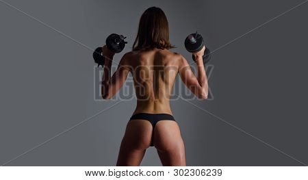 Woman Working Hard In The Gym. Slim Young Beautiful Girl Warming Up With Weights. Sportive Fitness M