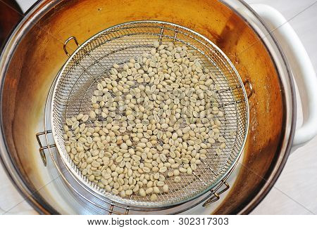 Homemade Roast Of Green Coffee Beans In Aerogrill. Top View