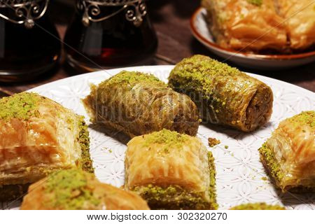 Middle Eastern Or Arabic Dishes. Turkish Dessert Baklava With Pistachio On Dishes