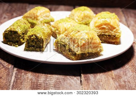 Middle Eastern Or Arabic Dishes. Turkish Dessert Baklava With Pistachio On Dishes