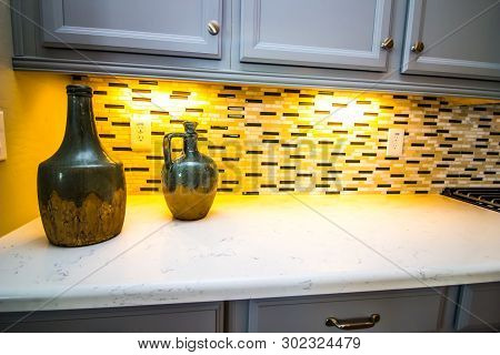 Two Decorative Jugs On Kitchen Counter With Backsplash