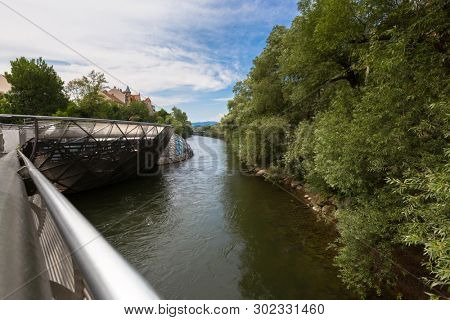 GRAZ, AUSTRIA - JULY 2018 : Murinsel bridge across Mur river in Graz, Austria on July 20, 2018. It is an artificial floating island. 