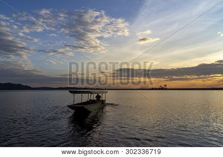Passenger Boats Across The Side Of The Dam. Evening Atmosphere Along The Water In The Dam. Sailing B