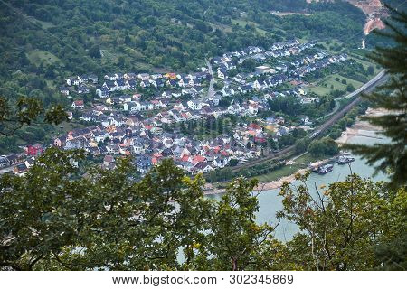 Aerial View Trough Tree Leaves To A German Town Trechtingshausen In Rheinland-pfalz State With River