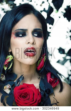 Pretty Brunette Woman With Rose Jewelry, Black And Red, Bright Make Up Kike A Vampire Closeup Red Li